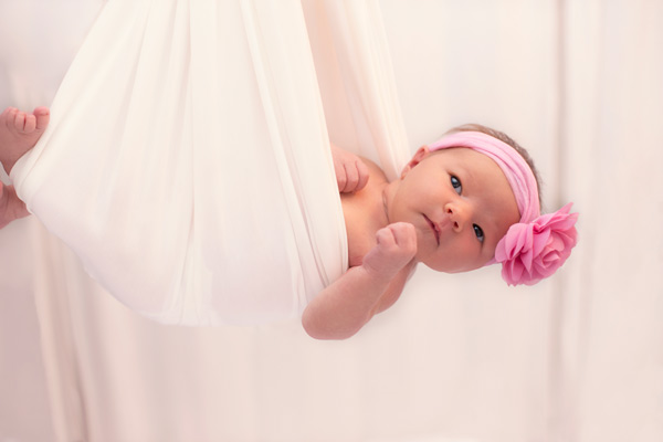 Newborn Baby Girl in Silk Hammock